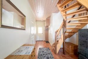 a hallway with wooden stairs and a mirror at Lomahuoneisto Kalajoen Hiekat B 4 in Kalajoki +37 photos