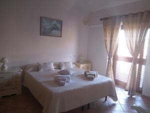 Ένα ή περισσότερα κρεβάτια σε δωμάτιο στο casa vacanza Rosanna