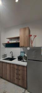 a kitchen with a sink and a refrigerator at Atonika Apartments Bitola in Bitola