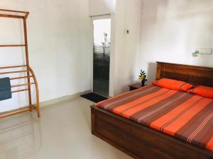a bedroom with a bed and a ladder in it at Sanithu Homestay Galle in Galle