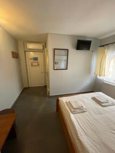 a small room with a bed and a door at Pensiunea Mario in Arad