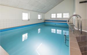 ブラーバンドにあるStunning Home In Blvand With 6 Bedrooms, Wifi And Indoor Swimming Poolの建物内の青い水のスイミングプール