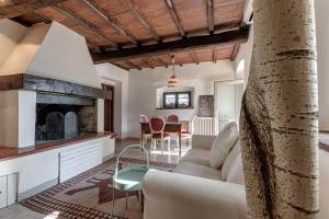 a living room with a couch and a fireplace at Poggio al Mandorlo in Greve in Chianti