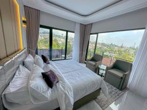 a bedroom with a white bed and a large window at Villa London Puncak in Sampal 2 +128 photos