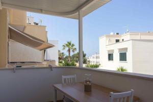 a table on a balcony with a view of a building at Boga & Vopa House in Savelletri di Fasano