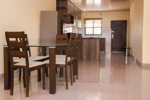 a kitchen and dining room with a table and chairs at JRK Apartments & Services Limited in Lusaka