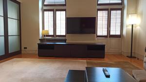 a living room with a tv and a couch at Residence 1898 in Warsaw