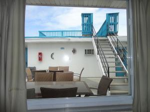 a view of a staircase from a window with a table and chairs at Binns Motor Inn in Wildwood