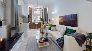 a living room with a white couch and a table at New Stylish Place for Couple in Bratislava