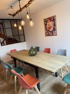 a dining room with a wooden table and chairs at Maison 4 chambres in Saint-Pol-de-Léon +9 photos