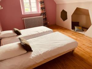 a room with three beds and a window at Maison 4 chambres in Saint-Pol-de-Léon