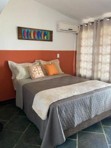 a bedroom with a large bed in a room at Pousada na Praia Maricá in Maricá