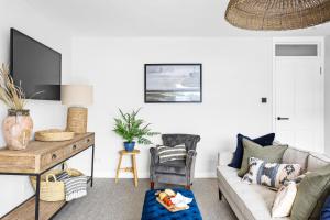 a living room with a couch and a table at Harbourside 3 - Luxury Riverside Apartment in Dartmouth