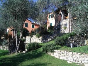 a stone house with a stone wall and a tree at CHARMING APARTMENT VILLA WITH POOL 010-46-cav-0009 in Rapallo