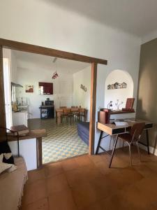 a living room with a table and a dining room at Du côté de chez nous in Cuxac-dʼAude