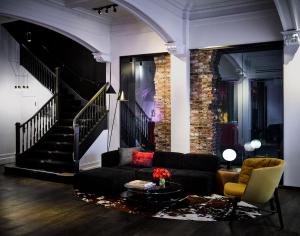 a living room with a couch and a staircase at Hotel Zeppelin San Francisco in San Francisco