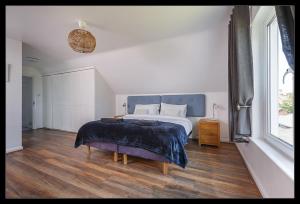 a bedroom with a bed and a large window at Overcliff Lodge, Mundesley sea view, sleeps 22 in Mundesley +20 photos