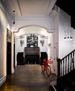 a red bike parked in front of a piano at Hotel Zeppelin San Francisco in San Francisco