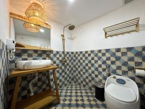 a bathroom with a toilet and a sink at Pisces Hotel Hue in Hue +56 photos