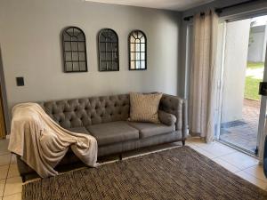 a living room with a couch in a room at Durbanville Holiday Accommodation in Cape Town