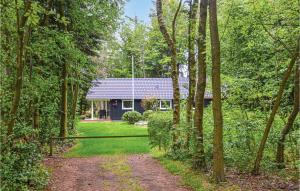 a house in the middle of a forest with a dirt road at 3 Bedroom Nice Home In Esbjerg V in Esbjerg