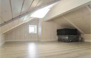 an empty attic with a vaulted ceiling and wood floors at 3 Bedroom Nice Home In Esbjerg V in Esbjerg