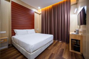 Ένα ή περισσότερα κρεβάτια σε δωμάτιο στο Semporna City Hotel
