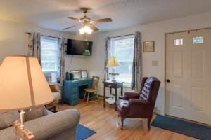 a living room with a couch and a chair and a desk at Cozy North Tazewell Home Rental on Clinch River! in Tazewell