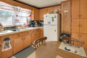 a kitchen with a table and a white refrigerator at Cozy North Tazewell Home Rental on Clinch River! in Tazewell