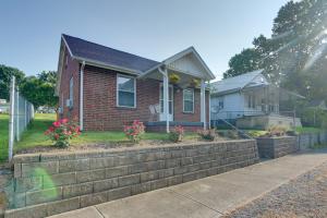 a house with a retaining wall in front of it at Cozy North Tazewell Home Rental on Clinch River! in Tazewell