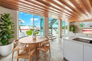 a kitchen and dining room with a table and chairs at 'Harbour Lights' Iconic Maritime-inspired Living in Wickham