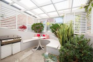 ニューカッスルにあるTimes Square Terrace - Vibrant Charm in Newy's Heartの植物とテーブルのある温室