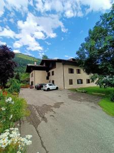 a house with a car parked in front of it at Casa Gianeta in Pinzolo