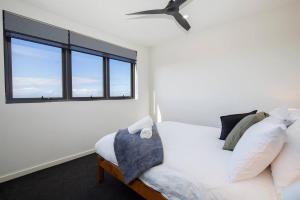 a bedroom with a white bed and a window at 'Highpoint Lookout' A Cool Charlestown Square Abode in Charlestown
