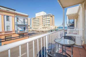 a balcony with a table and chairs on a building at 'Sandy Shores' A Spacious Newcastle Beach Escape in Newcastle