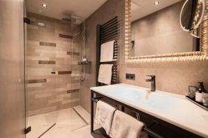 a bathroom with a sink and a shower at Apart Sailers in Sankt Anton am Arlberg