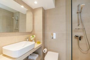a bathroom with a sink and a shower at Nissi Park Hotel in Ayia Napa +27 photos