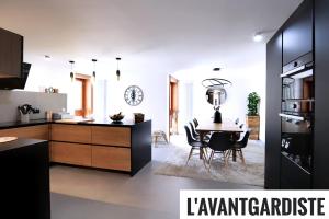a kitchen and dining room with a table and chairs at L'AvantGardiste, Spacious 6 bedrooms duplex, panoramic view in Crans-Montana