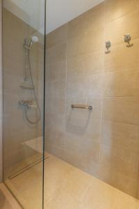 a bathroom with a shower with a glass door at Nissi Park Hotel in Ayia Napa