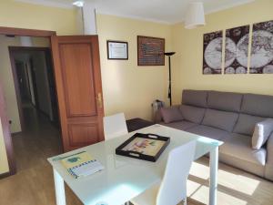 a living room with a table and a couch at Apartamento Paseo Fluvial in Tui
