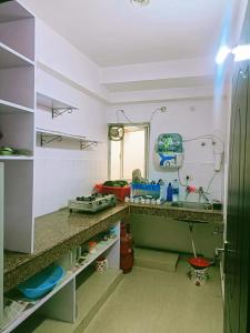 a kitchen with a counter and a sink at Pretty Garden View Apartment 3BHK Furnished Flat near Kashi Vishwanath Temple in Varanasi