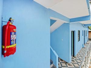 a fire hydrant on the side of a blue building at OYO Hotel 49339 On The Rocks in Arambol