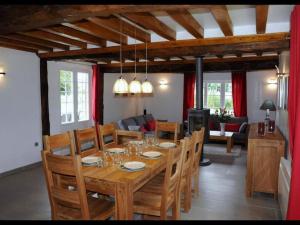 a dining room with a wooden table and chairs at Le Pressoir de Bigard - chaumière normande - 8 personnes in Campigny