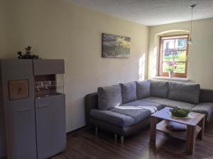 sala de estar con sofá y mesa en Ferienwohnung Aus-Zeit auf dem Lande en Bad Gottleuba