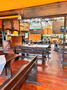 a dining room with wooden tables and benches at Casa Ott in Prisaca Dornei +19 photos