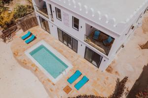 an overhead view of a building with a pool and chairs at Villa Citrus Zanzibar in Jambiani