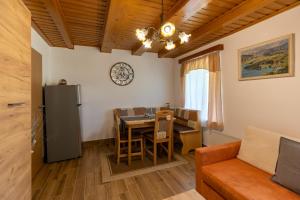 a kitchen and dining room with a table and a couch at Počitniška hiša Taler in Bohinj