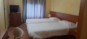 Posteľ alebo postele v izbe v ubytovaní Hotel Ceretto