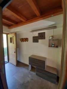 a living room with a bench and a door at Tranquillità e Relax in Villeneuve