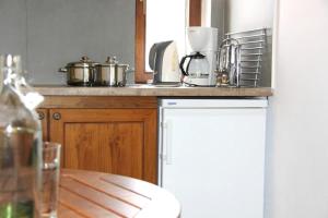 a kitchen with a counter top with pots and pans at PLATANOFYLLA Studios & Apartments in Kala Nera